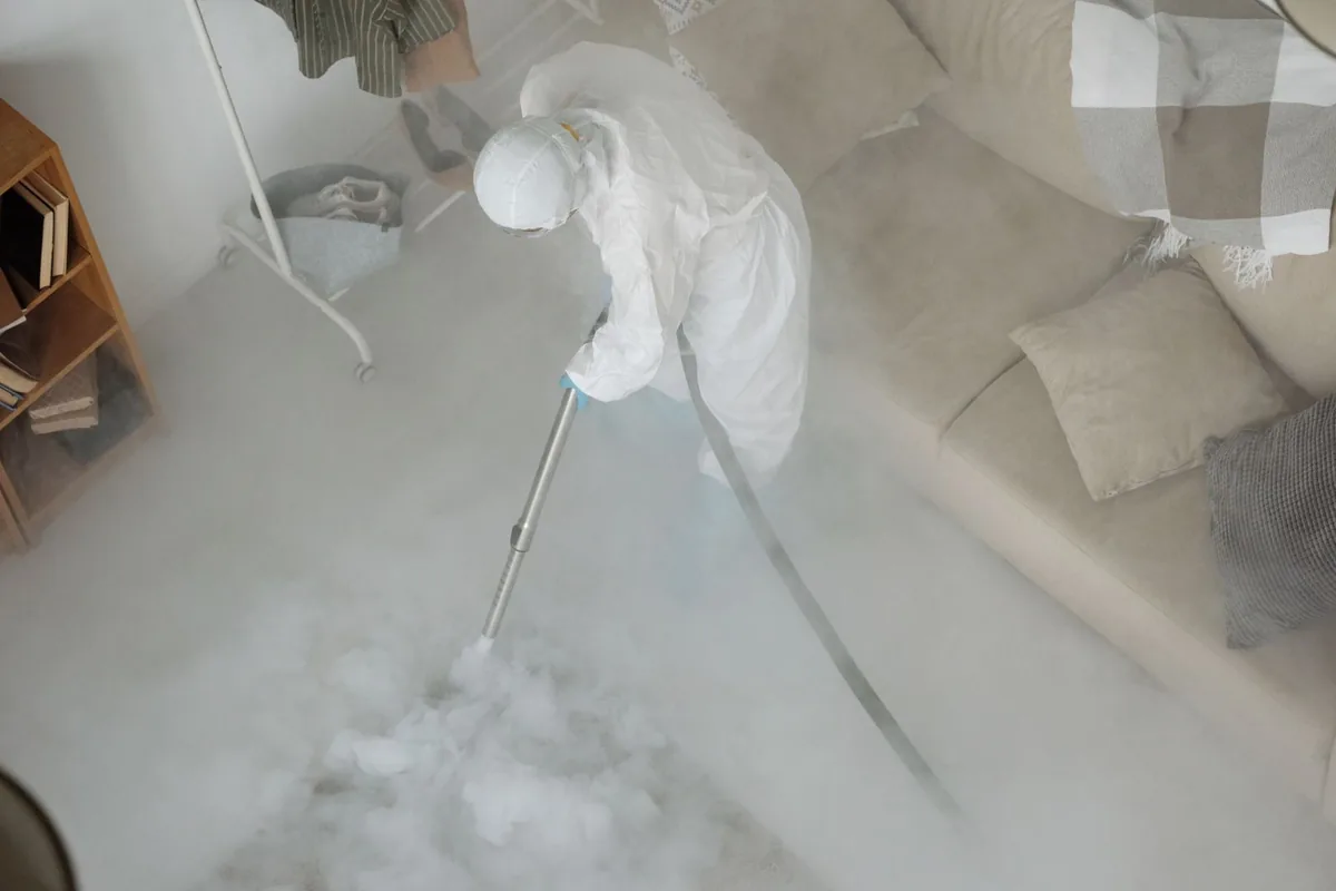 Biohazard cleanup technician in protective equipment, Madrid, IA